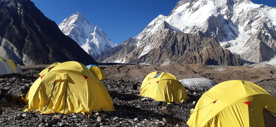Expedition tents below K2 and the high peaks of the Karakoram in Pakistan